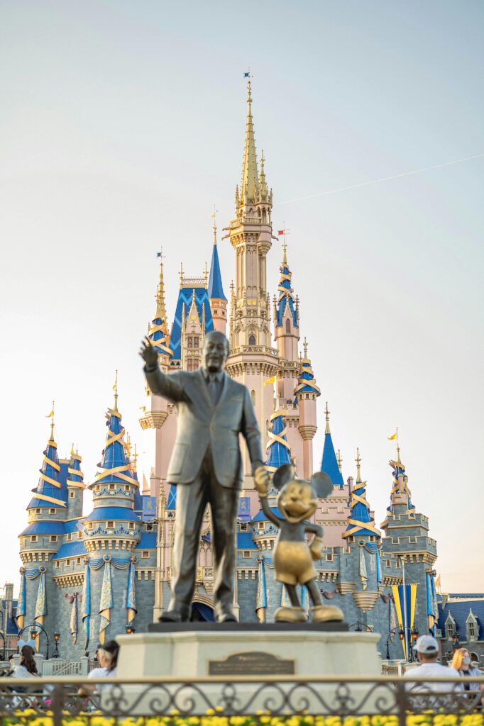 Iconic Walt Disney and Mickey Mouse statue in front of Cinderella Castle at Disney World
